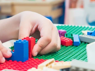 Child playing with Lego block