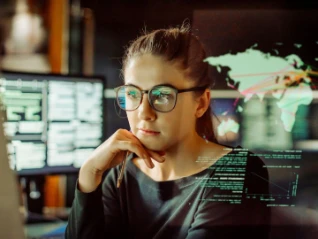 young female it worker looking at screen jpg