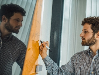 Atradius Colleague working on a board in the Paris Office