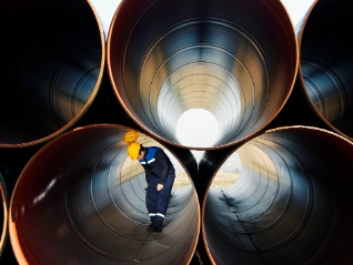 Worker inside industrial pipes