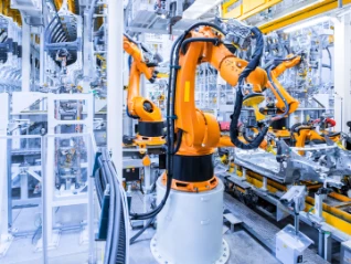 Industrial robots assembling a vehicle body on an automated automotive production line