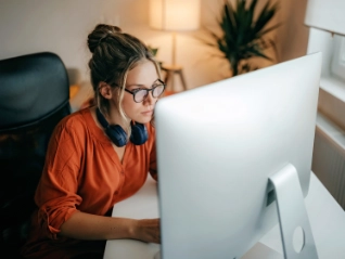 Woman with headphones working at a computer