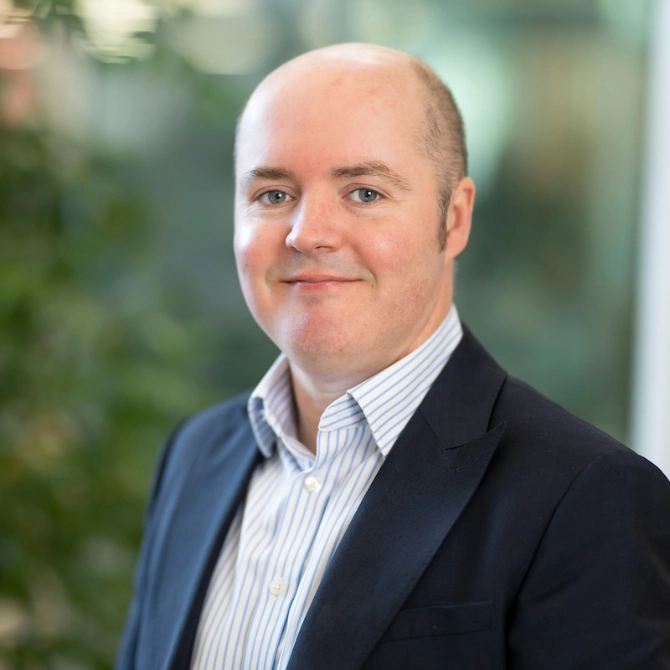 Head shot of Owen Bassett stood outside the Atradius building in Cardiff