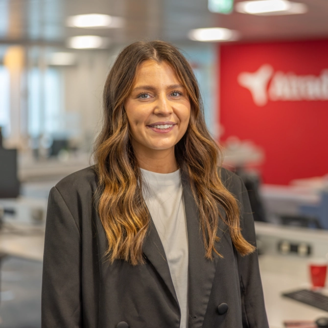 Headshot of Ruby Hartery outside the Atradius Building in Cardiff