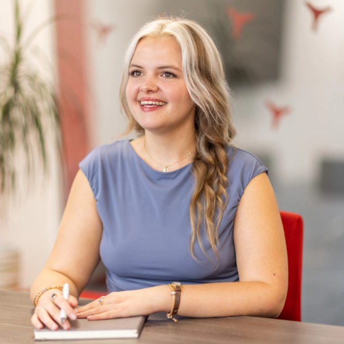 Abigale Jones smiling while sat in a meeting room