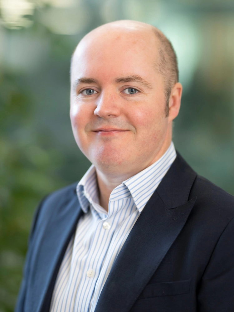 Head shot of Owen Bassett stood outside the Atradius building in Cardiff