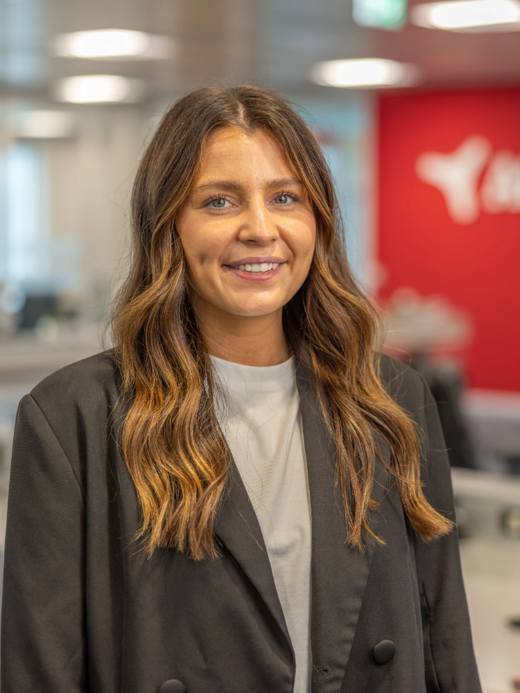 Headshot of Ruby Hartery outside the Atradius Building in Cardiff