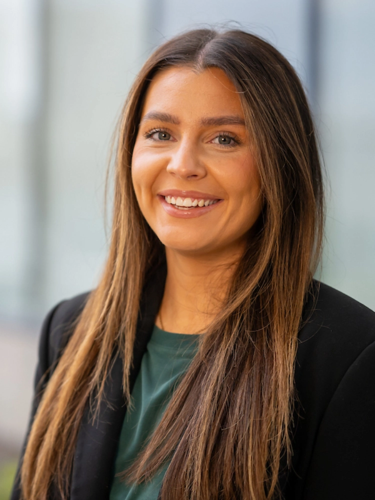 Headshot of Ruby Hartery outside the Atradius Building in Cardiff