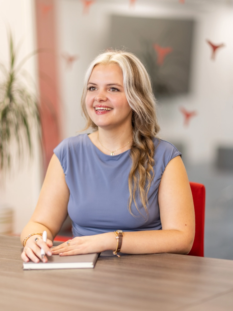 Abigale Jones smiling while sat in a meeting room