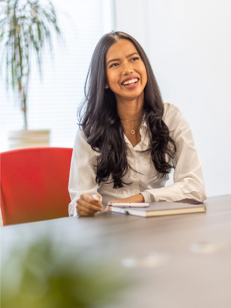 Nadia Sukmawati-Jones laughing at a meeting