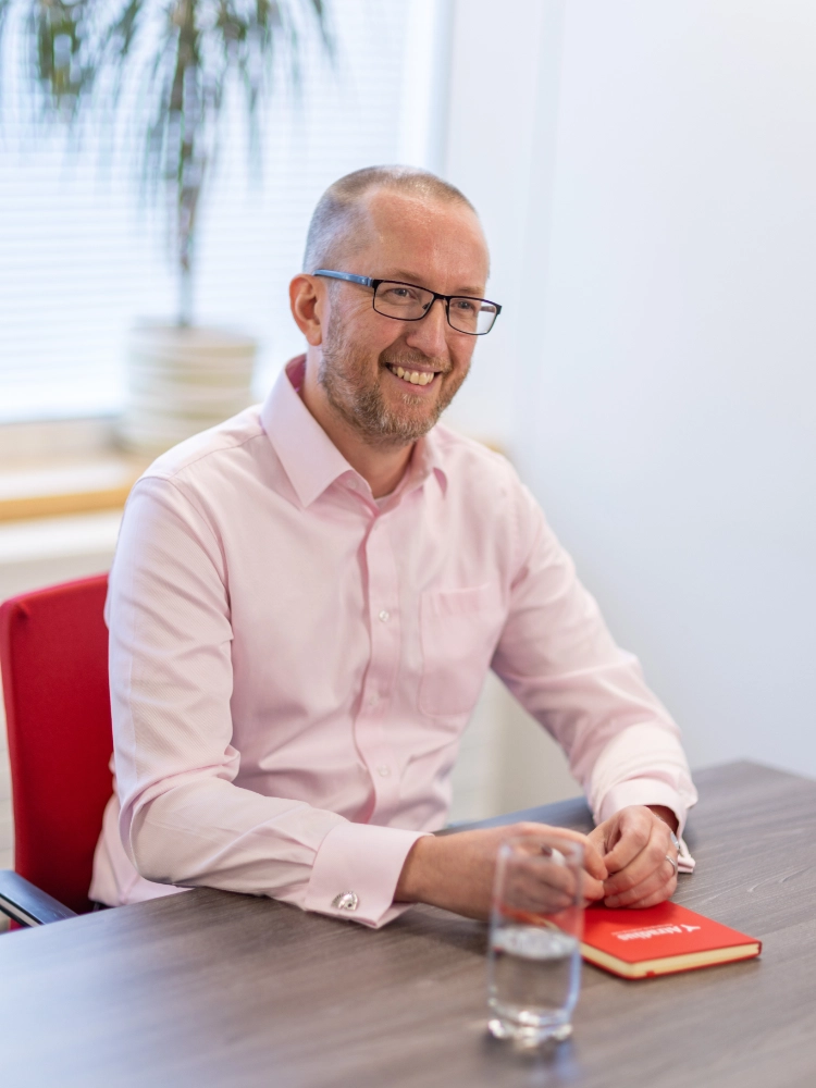 Kris Lewis sat at a desk