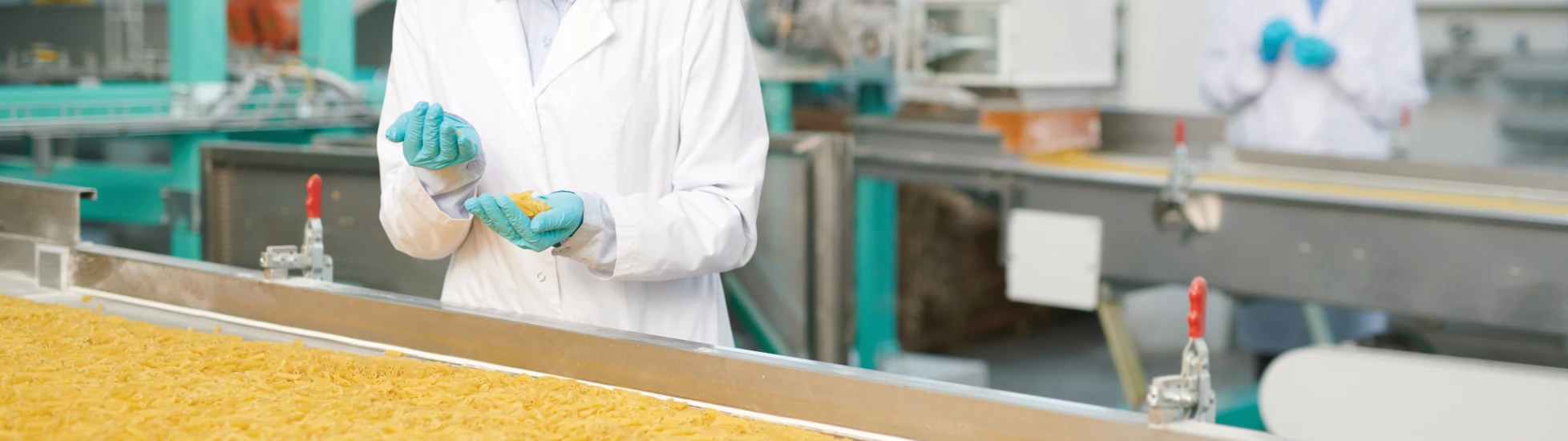 Woman checking pasta in a factory