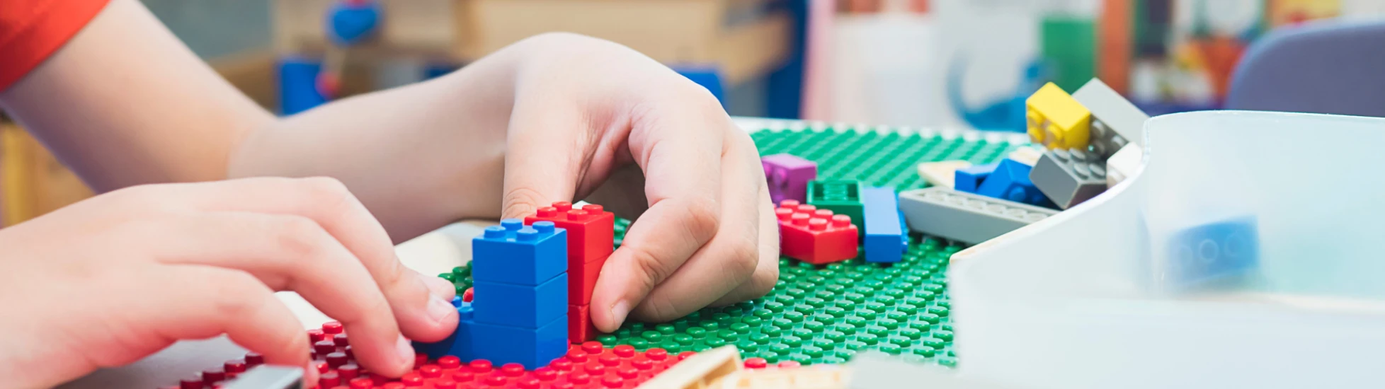 Child playing with Lego block