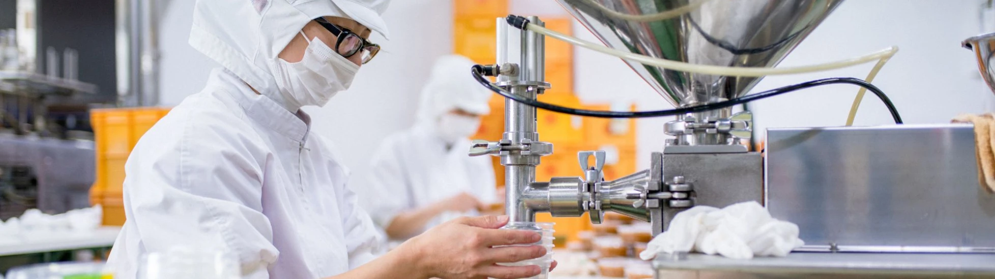 Person in protective clothing working in a food factory