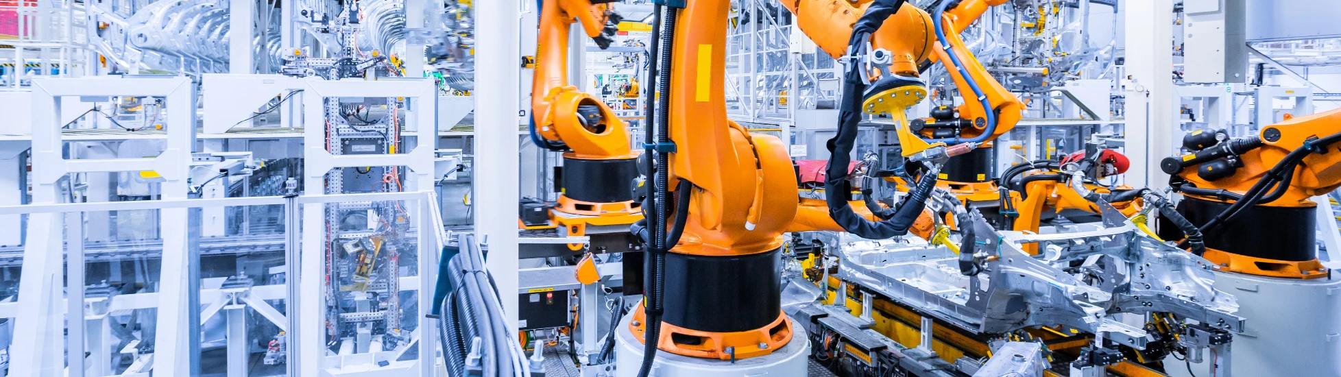 Industrial robots assembling a vehicle body on an automated automotive production line