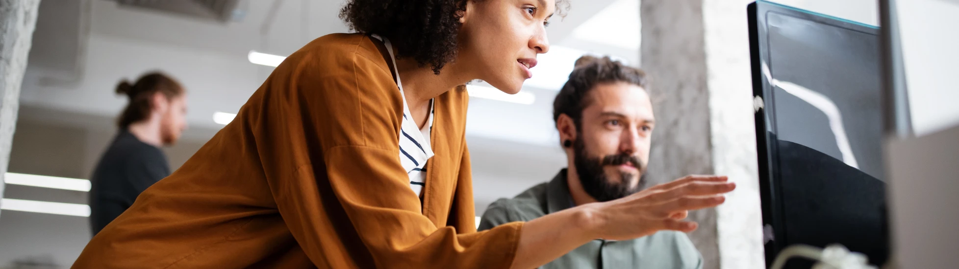 Two employees having a discussion at a desk