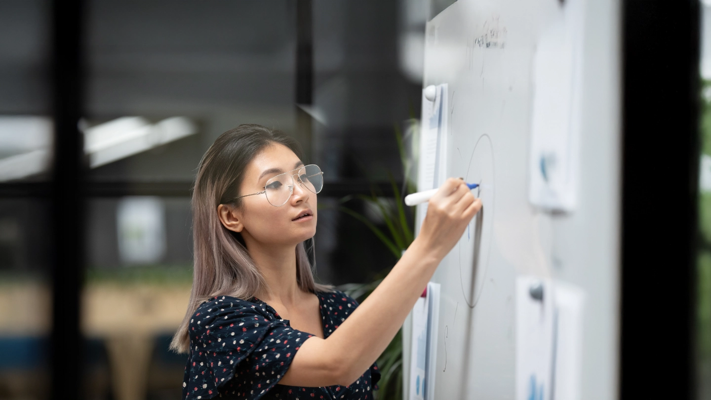 Woman writing on a whiteboard