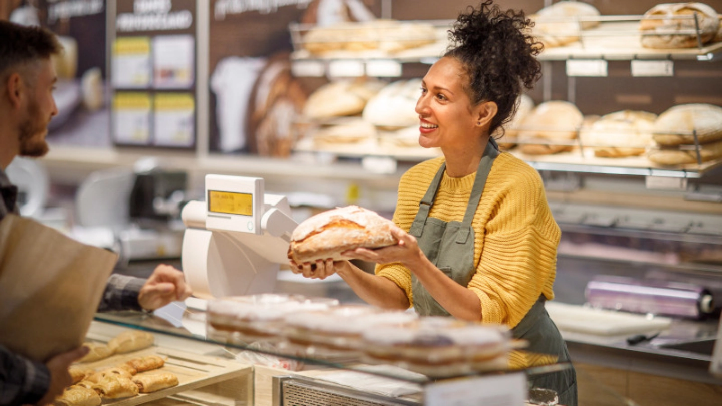 Woman selling bread at a bakery