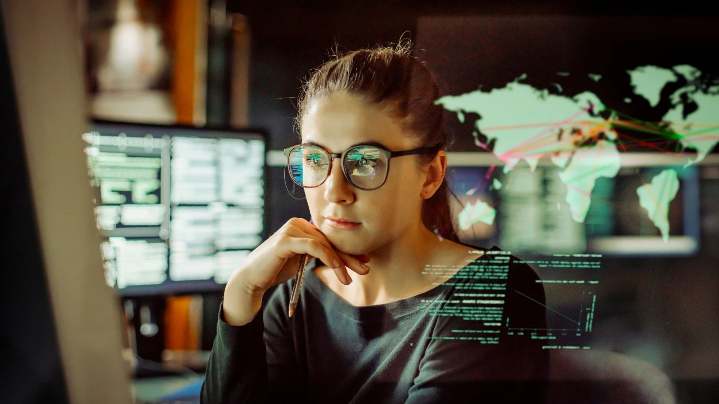 young female it worker looking at screen jpg