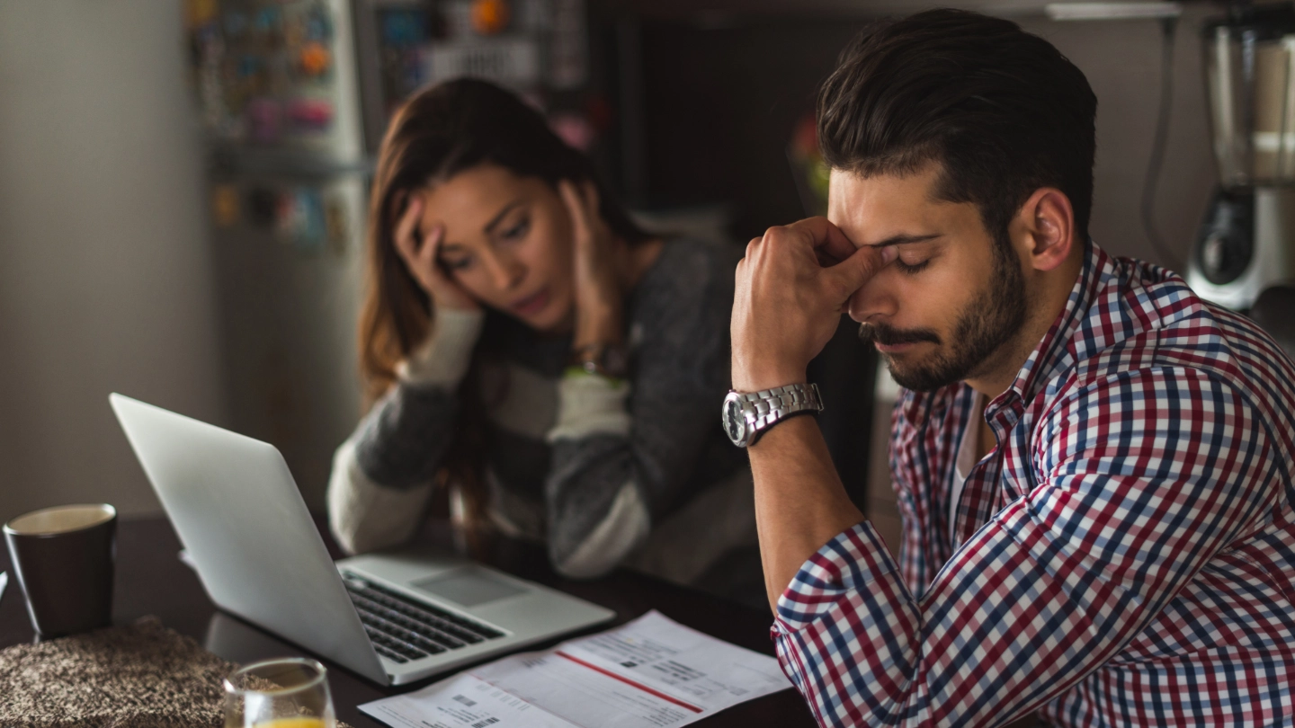 Stressed people looking at a laptop