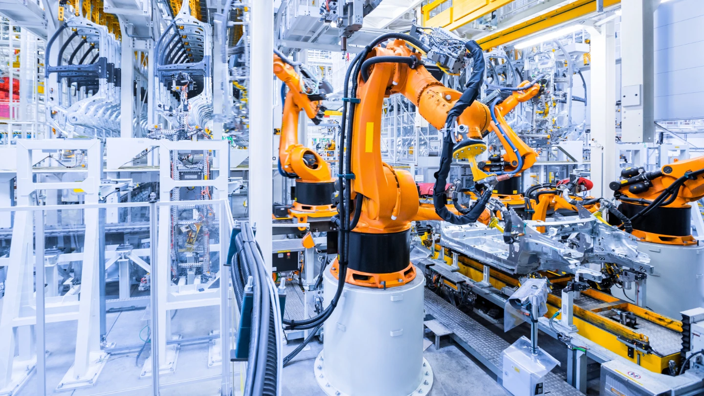 Industrial robots assembling a vehicle body on an automated automotive production line