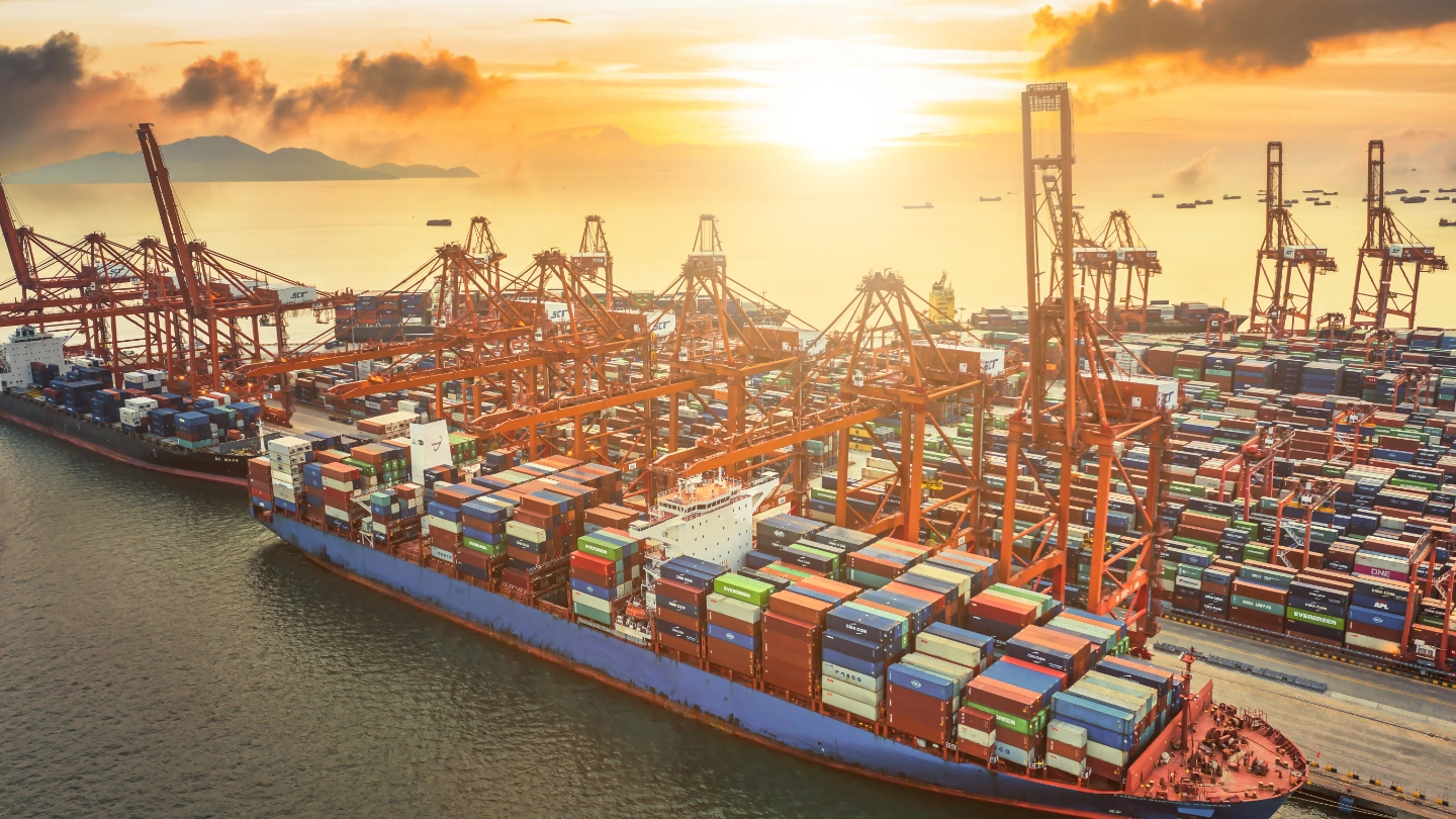 Aerial view of large ship in dock with containers