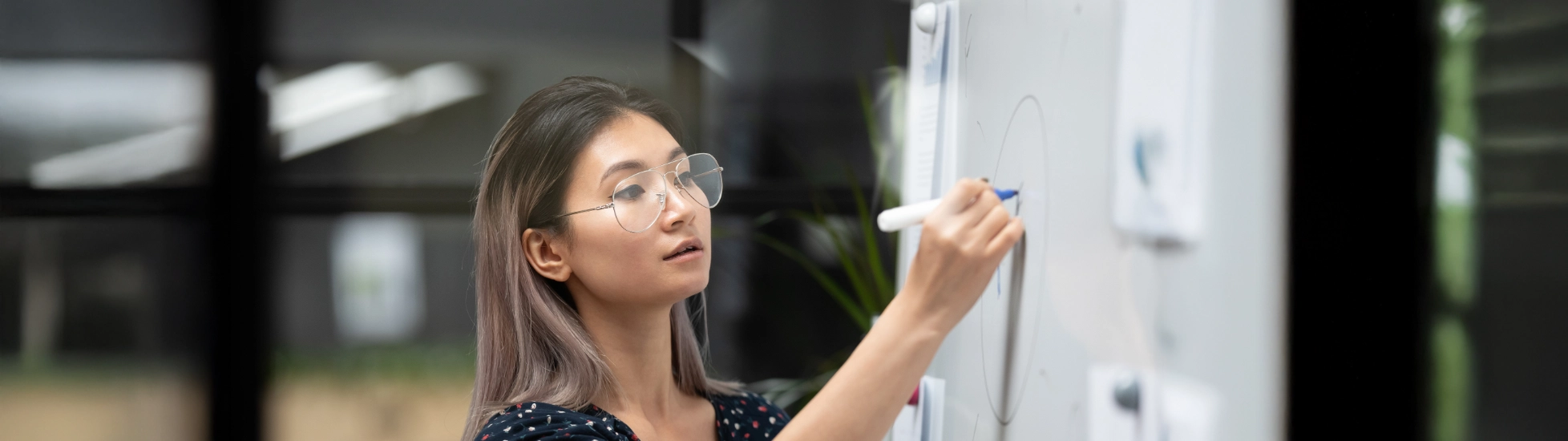 Woman writing on a whiteboard