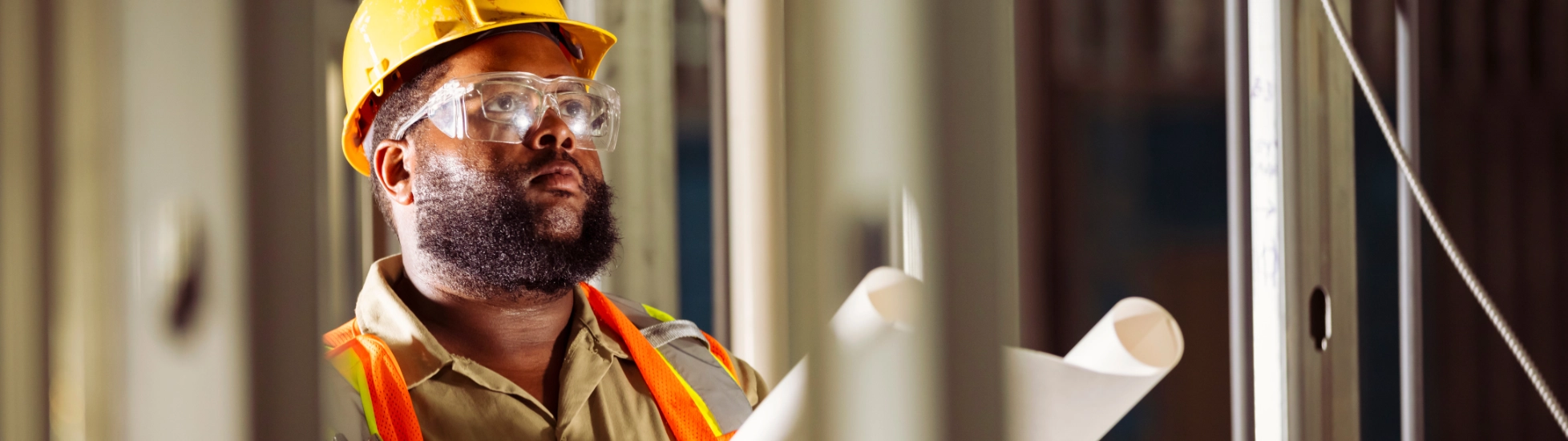 Construction worker reviewing drawings