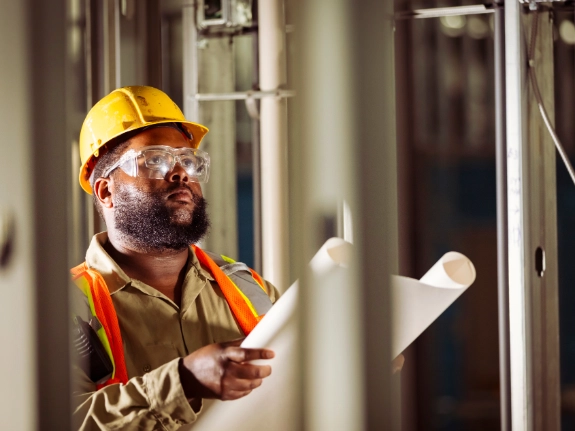 Construction worker reviewing drawings
