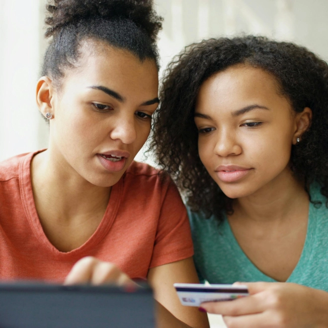 Two women paying for online shopping