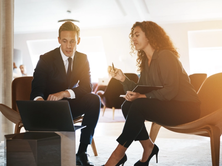 Two people having a conversation sitting in relaxed chairs image